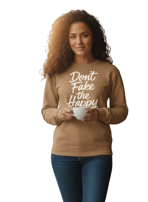Woman wearing a beige sweatshirt with text, holding a cup in a casual setting.