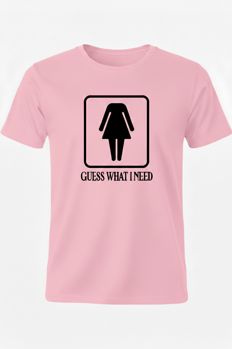 Pink t-shirt with black graphic and text 'Guess What I Need' on a white background