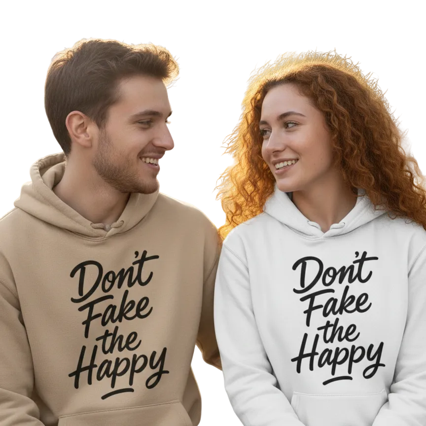 Two people wearing hoodies with 'Don't Fake the Happy' text in a park setting.